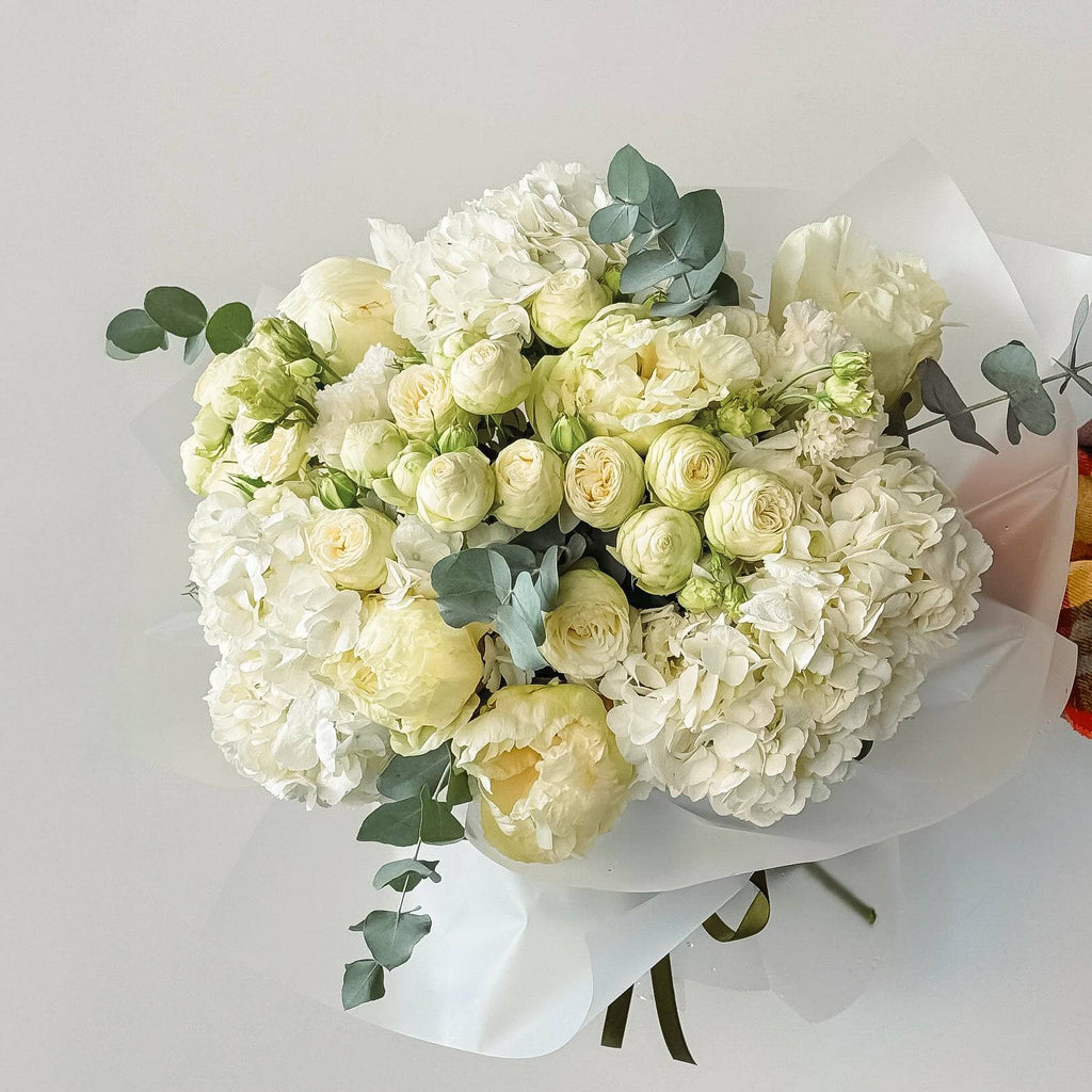 Pure Elegance bouquet with white roses and hydrangeas in premium white wrap