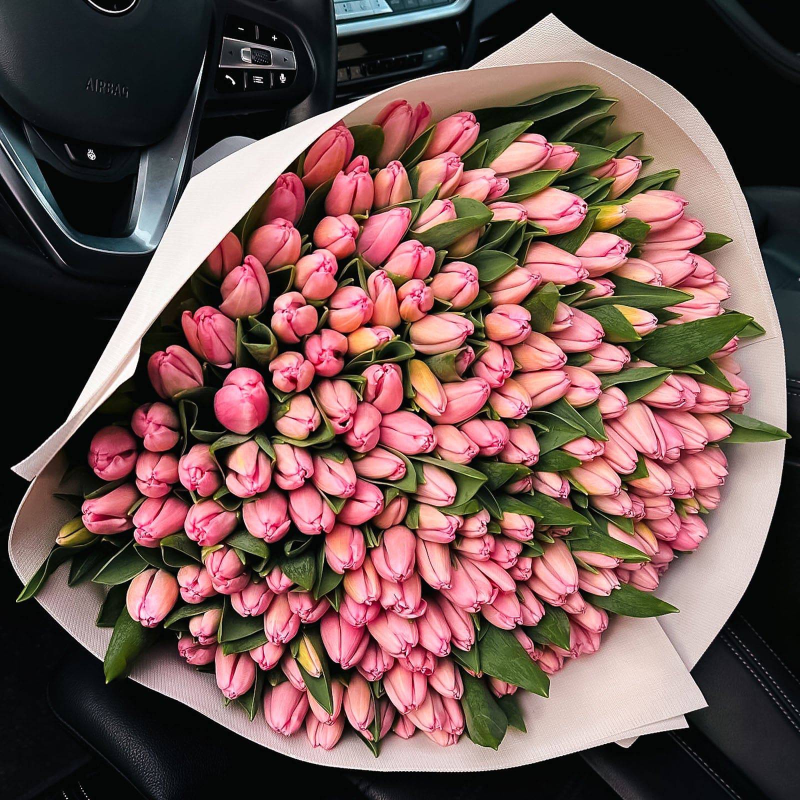 Overhead view of 200 pink tulip bouquet in white wrap