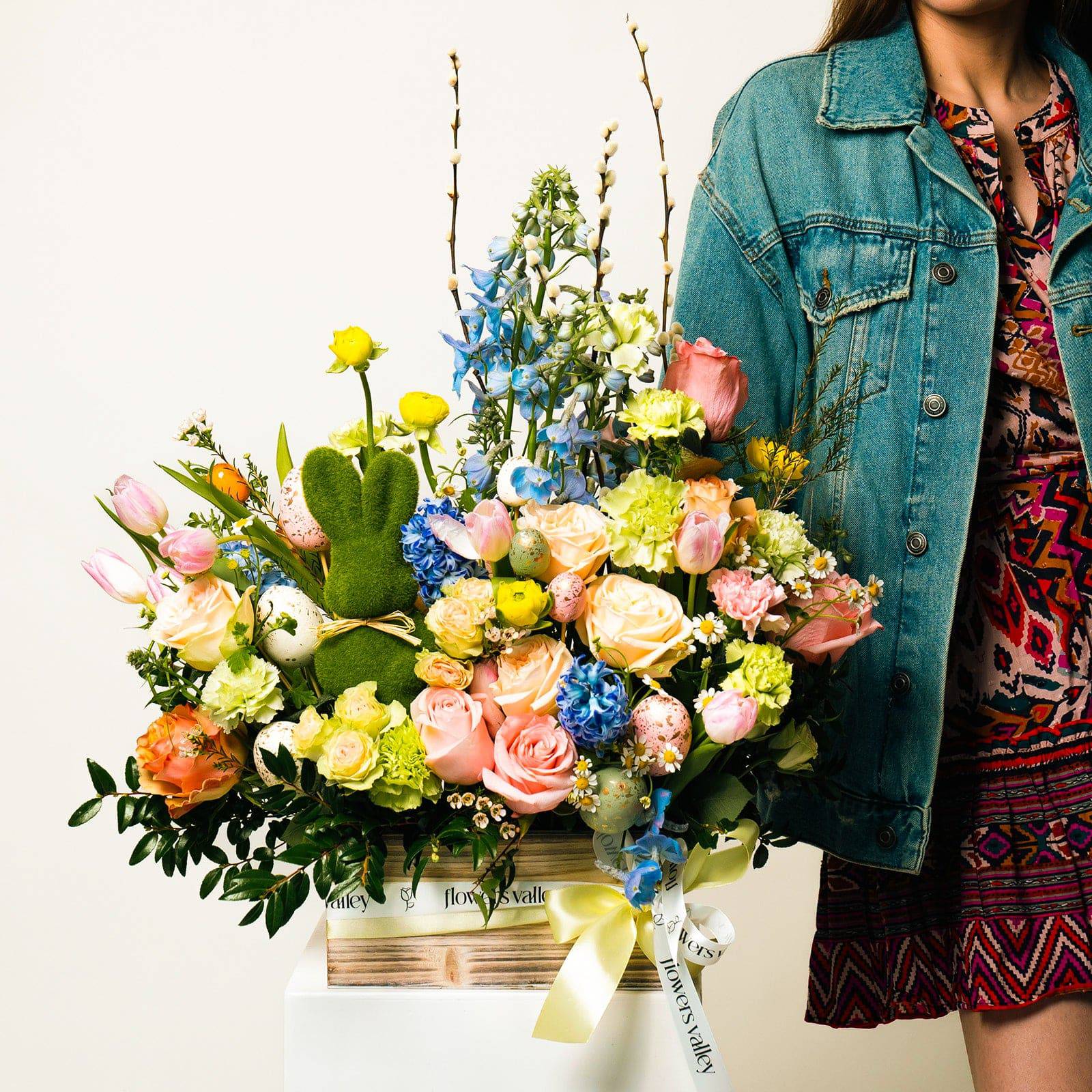Model holding Easter Meadow bouquet with pastel spring flowers