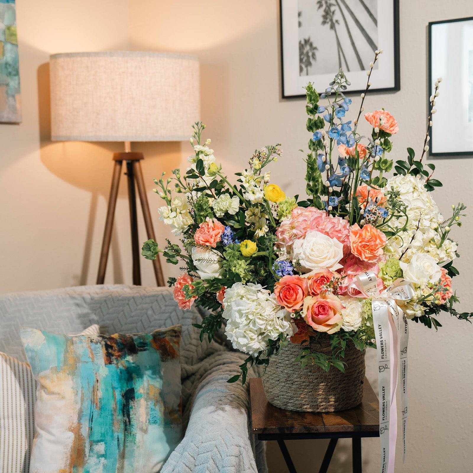 Spring floral basket styled on a side table with natural light