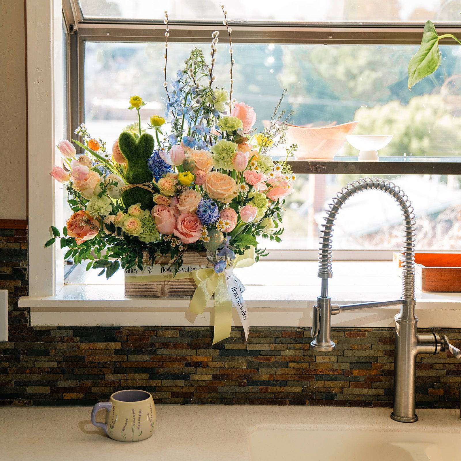 Pastel spring bouquet in white vase styled by window