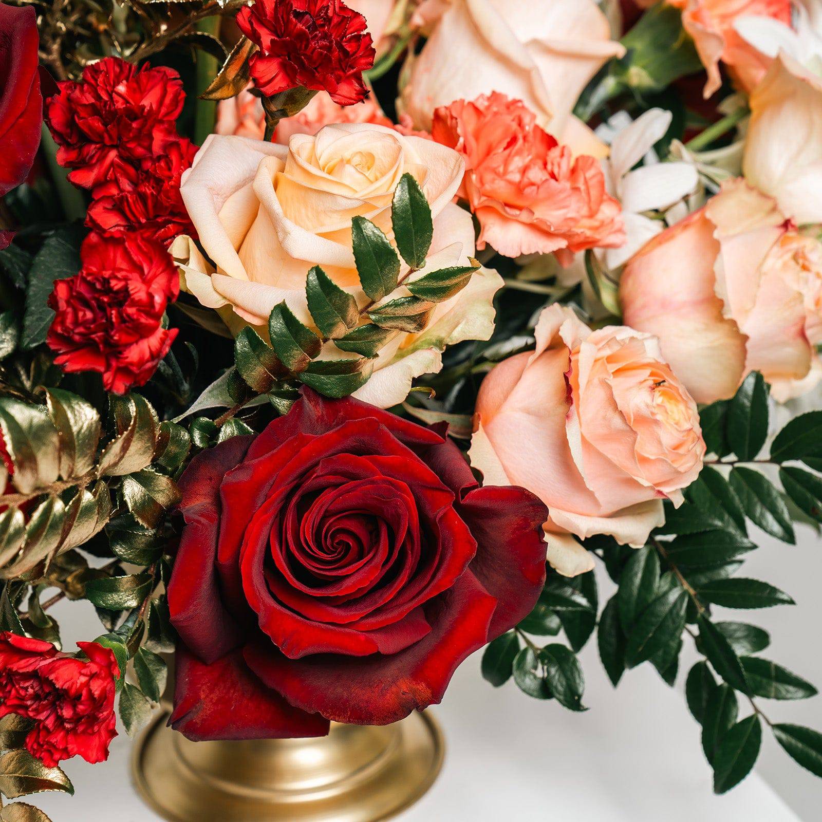 Close-up of red and peach roses from Opulent Romance bouquet