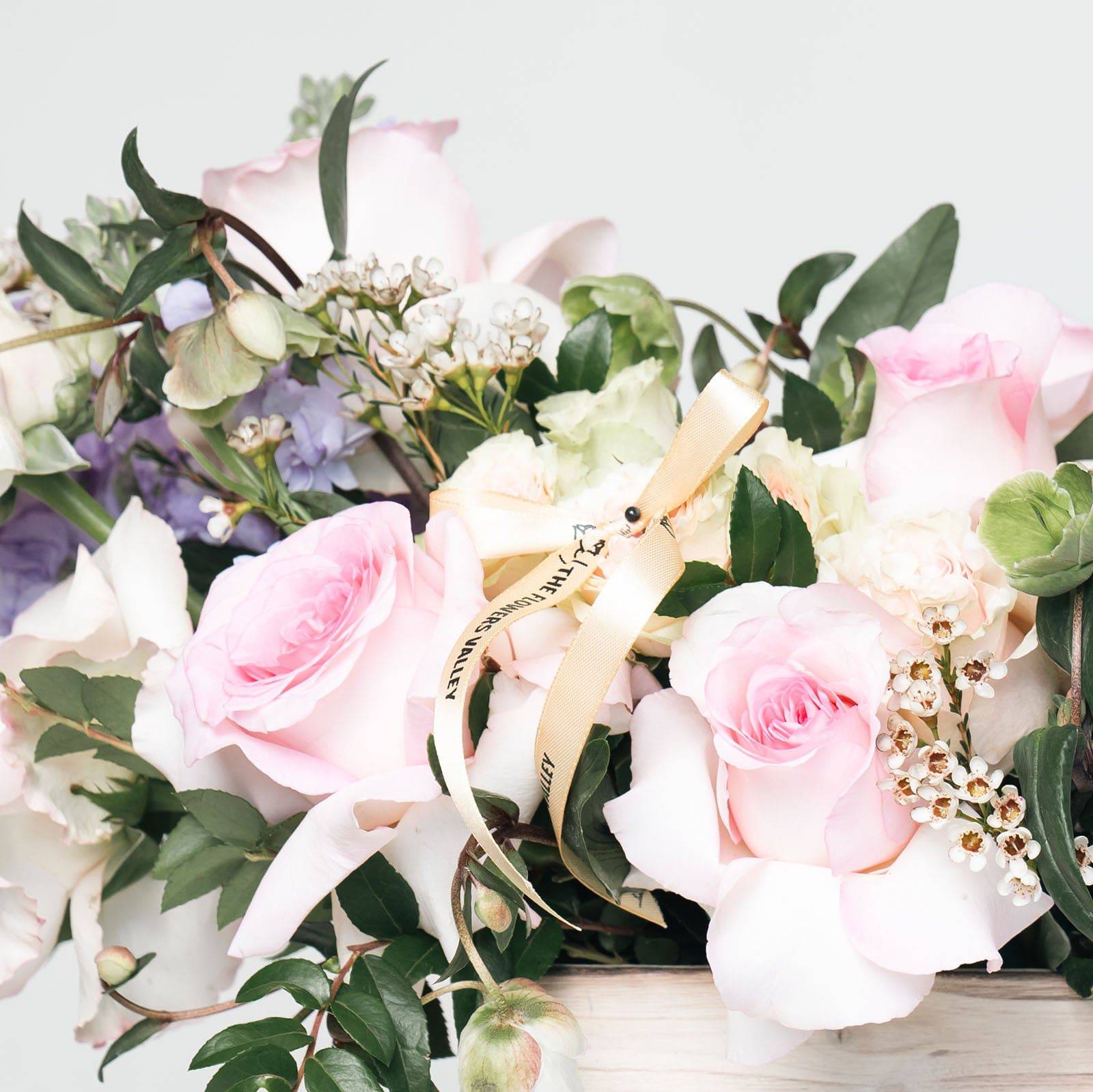 Pastel flower arrangement with roses and lisianthus in soft purple and pink tones