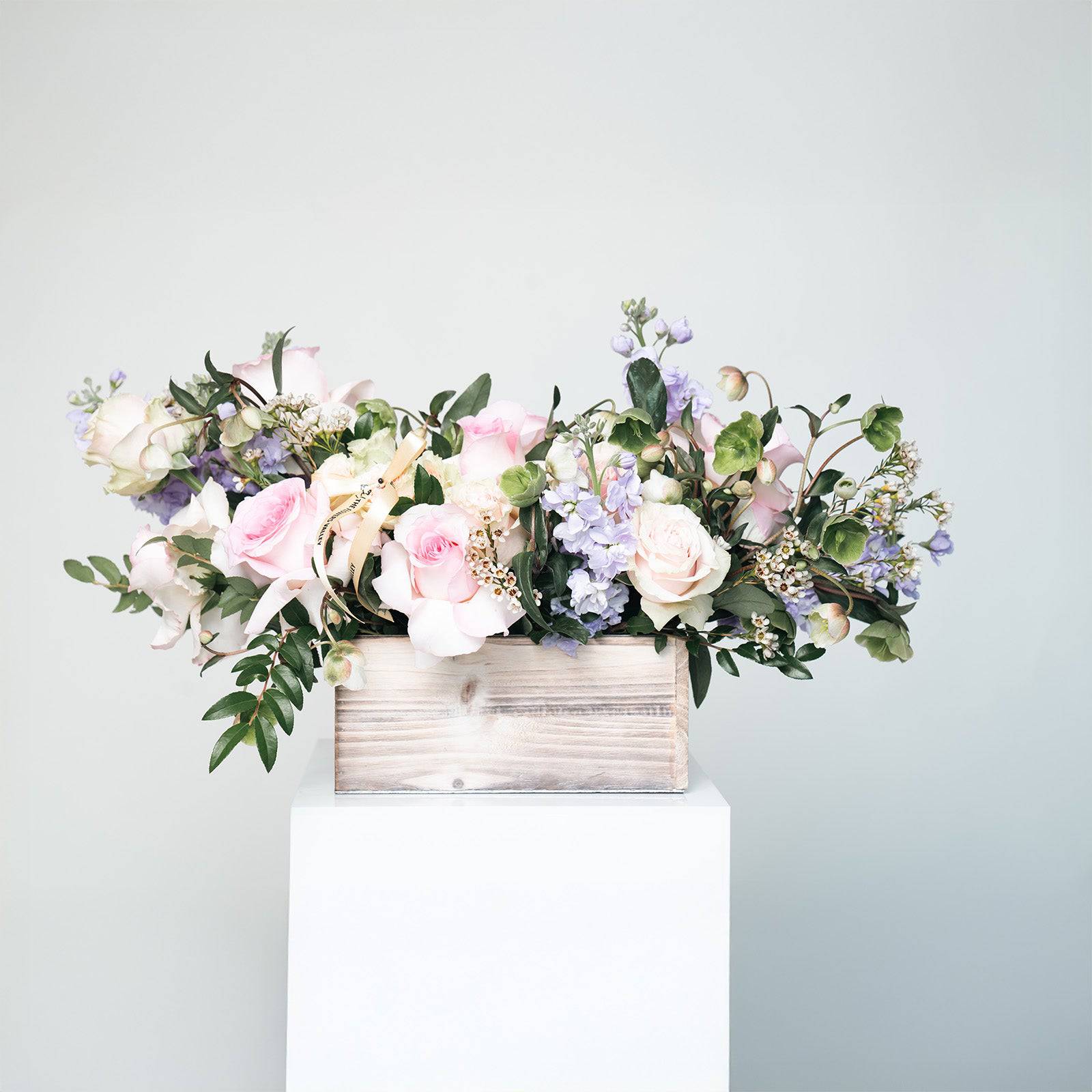 Lavender Bliss bouquet with blush roses and lavender stock in a white wooden box
