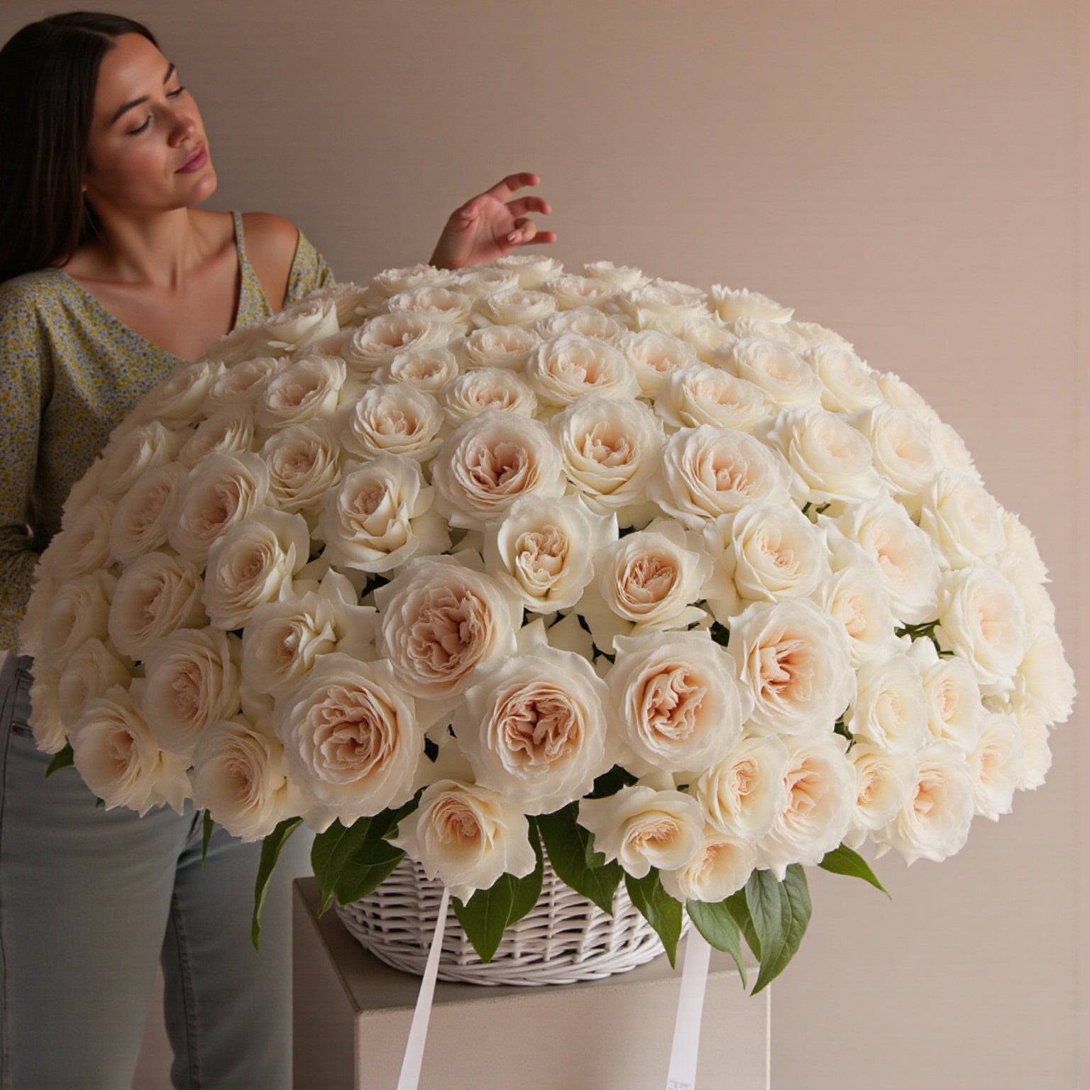 Woman holding large White O’Hara rose basket—luxury floral gift for romantic or elegant occasions.