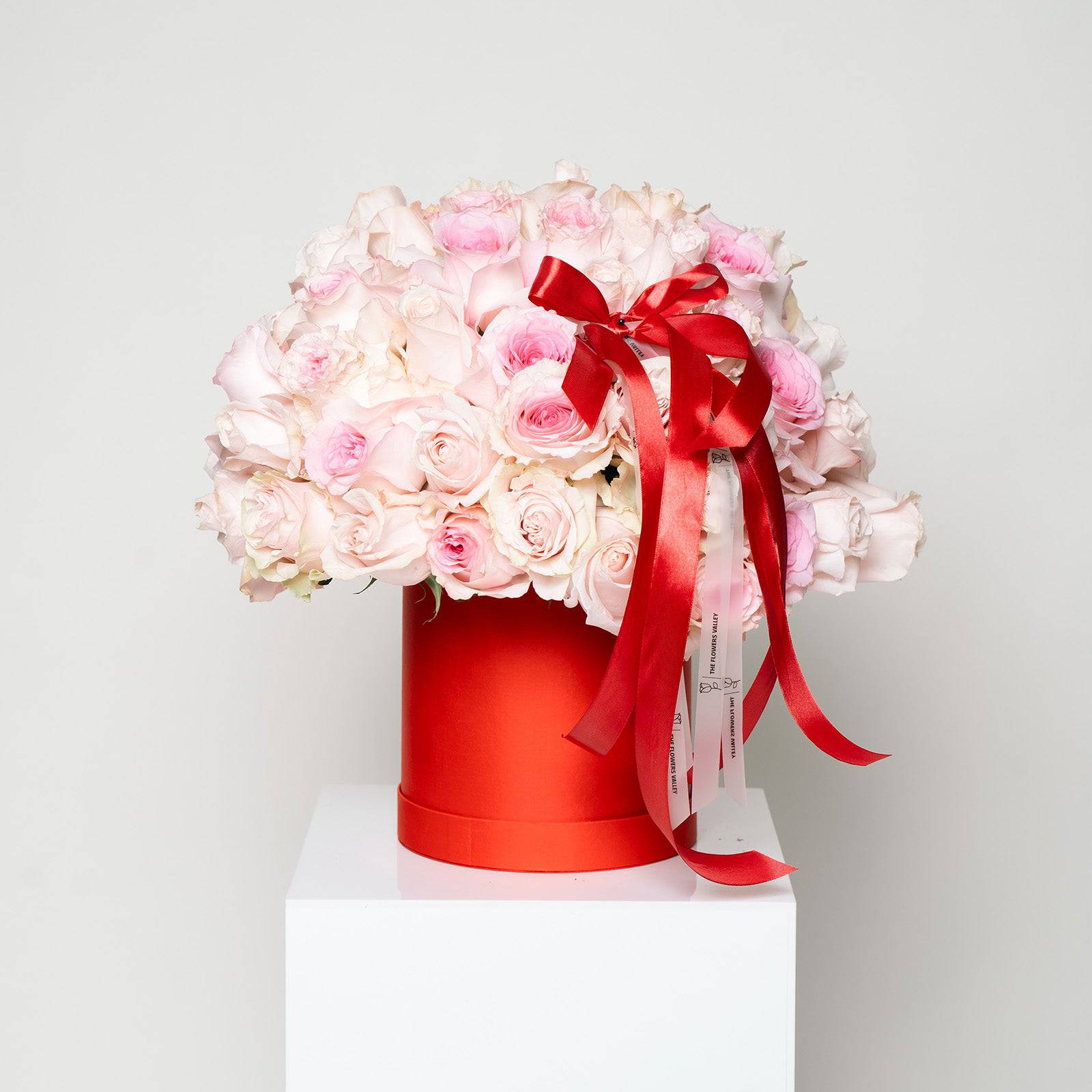 Sweet Kiss bouquet with blush roses in red hatbox tied with satin ribbon