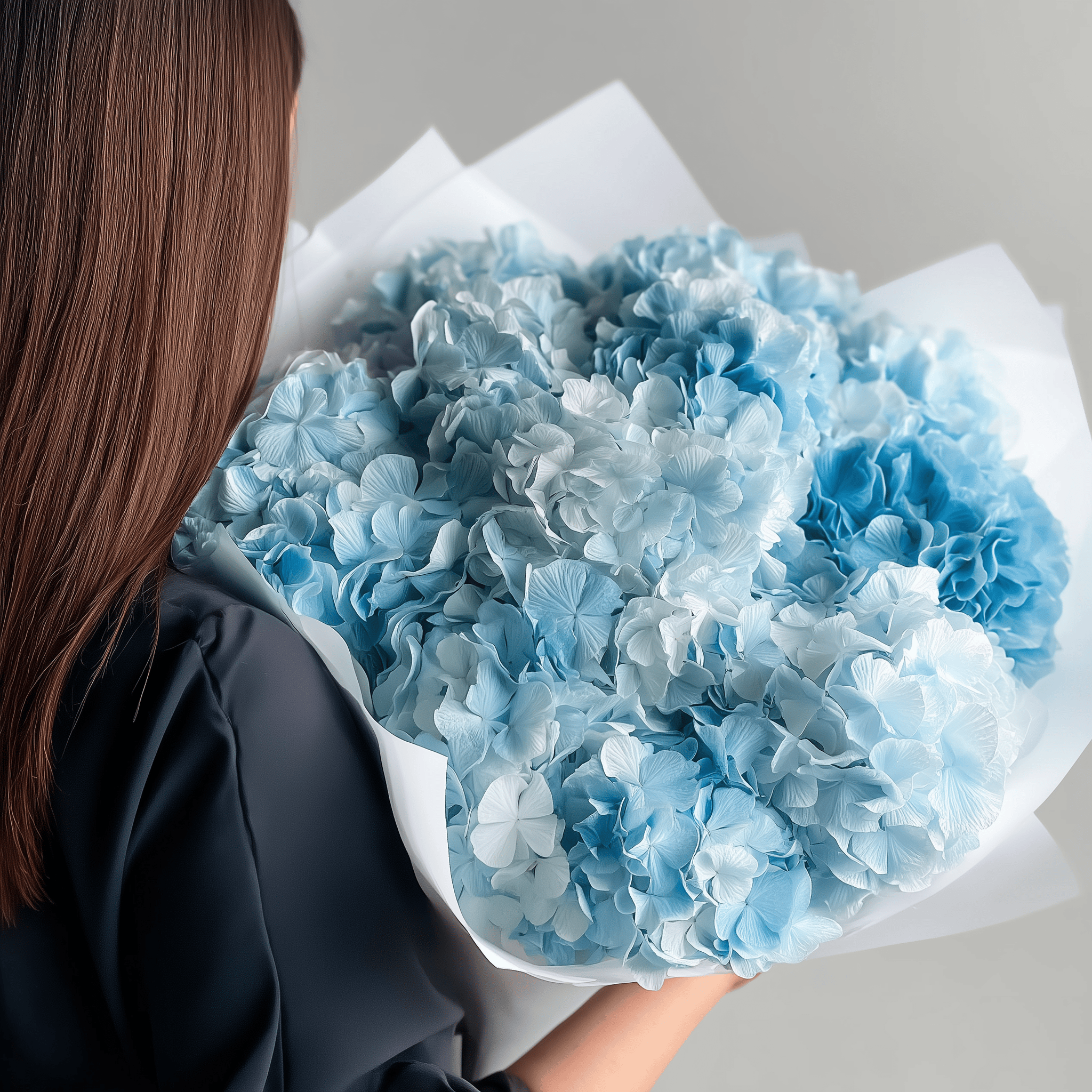Mid-size sky blue hydrangea bouquet held from the back—light and airy design.