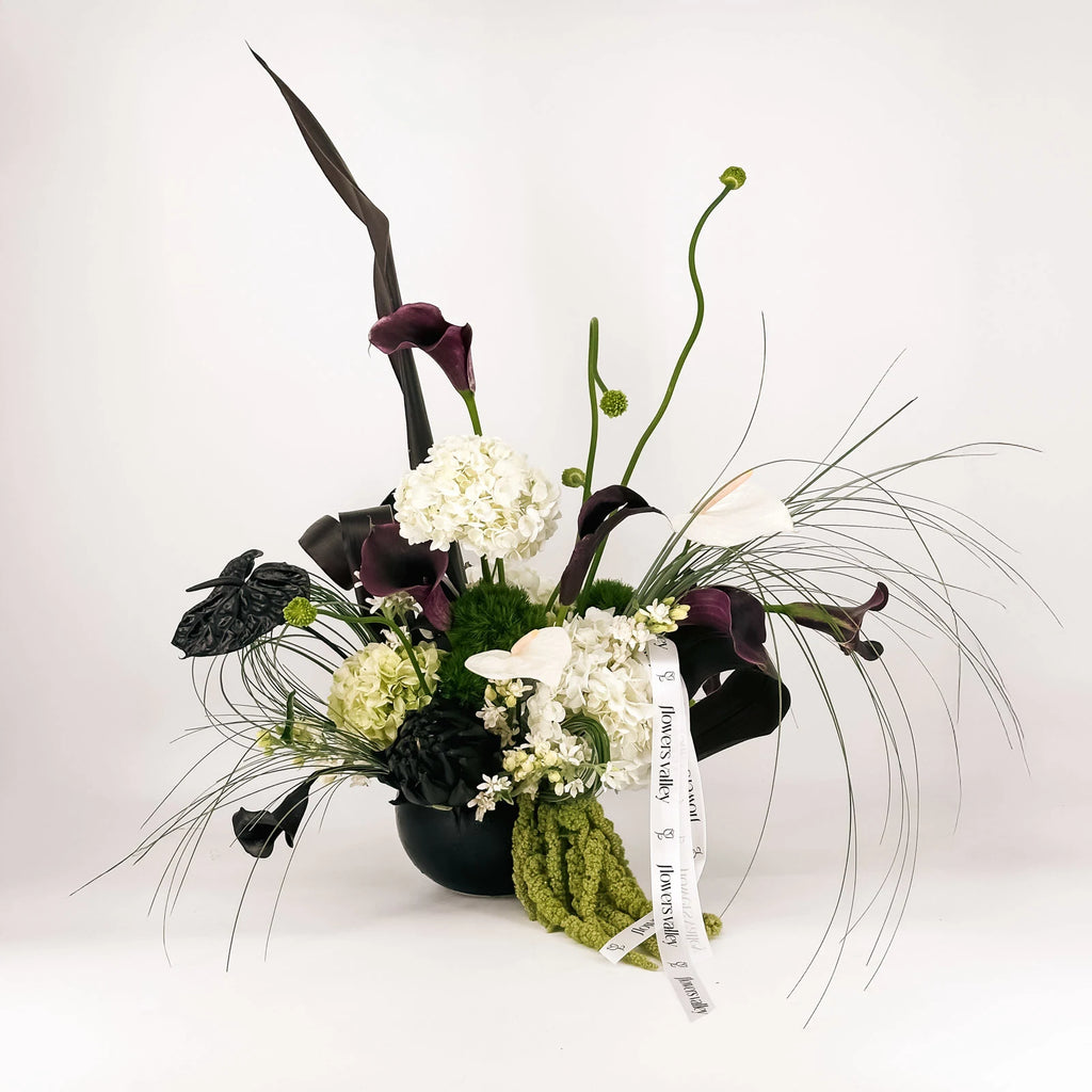 Luxury floral arrangement with black calla lilies, white hydrangeas, and anthuriums – Modern Noir Elegance by Flowers Valley