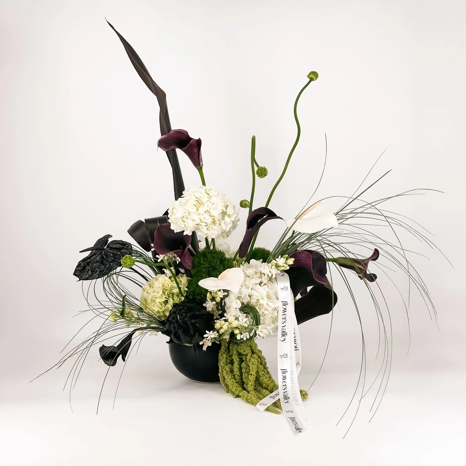 Luxury floral arrangement with black calla lilies, white hydrangeas, and anthuriums – Modern Noir Elegance by Flowers Valley