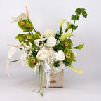 Modern white and green flower arrangement, the Urban Serenity Arrangement, in a concrete vase, available for local delivery from Flowers Valley